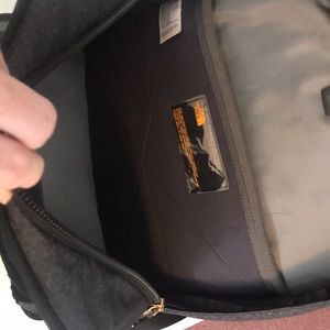 The North Face black and gold book bag